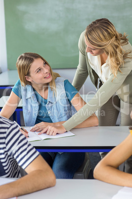 Teacher helping student in class Teacher helping student in class