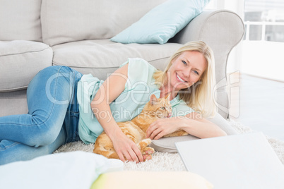 Happy woman with dog on rug
