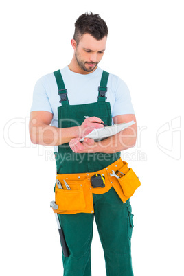 Repairman writing on a clipboard