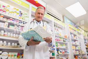 Smiling doctor reading a prescription
