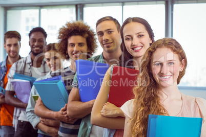 Fashion students smiling at camera together