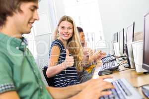 Student gesturing thumbs up in computer class