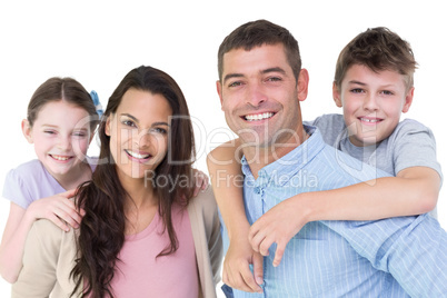 Portrait of parents giving piggyback ride to children