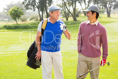 Golfer friends walking and chatting