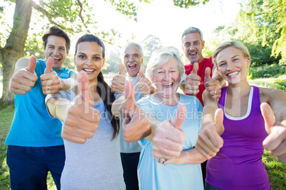 Happy athletic group with thumbs up