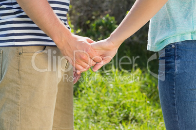 Cute couple in the park holding hands