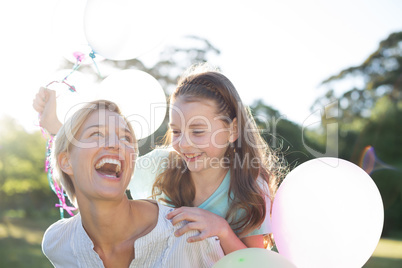 Happy mother playing with her daughter