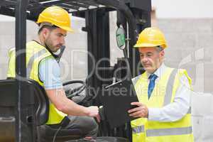 Forklift driver talking with his manager