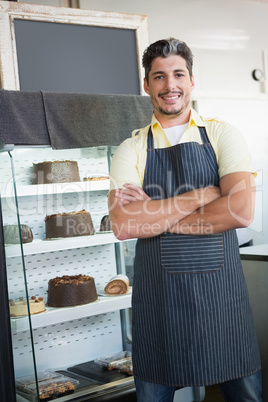 Cheerful worker posing with arms crossed