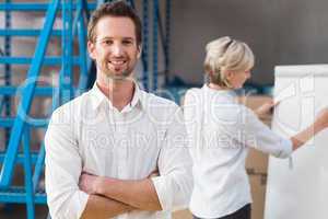 Warehouse manager smiling at camera