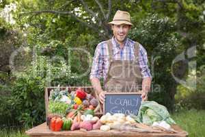 Happy farmer showing his produce