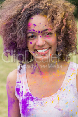 Young woman having fun with powder paint