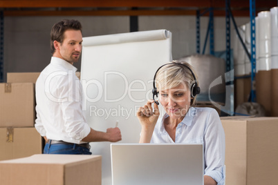 Warehouse manager using laptop during a presentation