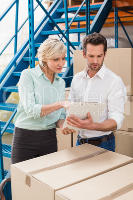 Focused warehouse managers with clipboard