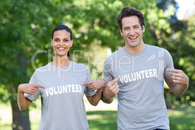 Happy volunteer couple smiling at the camera