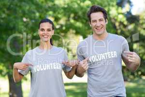 Happy volunteer couple smiling at the camera