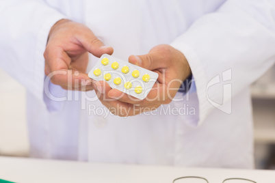 Pharmacist holding blister packs