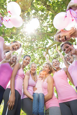 Smiling women in pink for breast cancer awareness