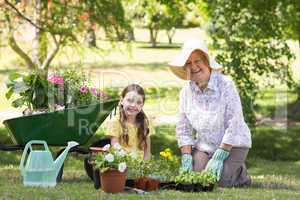 Happy grandmother with her granddaughter gardening