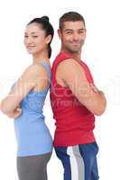 Fit man and woman smiling at camera together