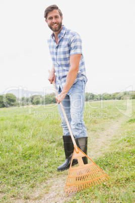Happy man raking his farm