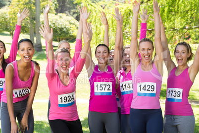 Smiling women running for breast cancer awareness