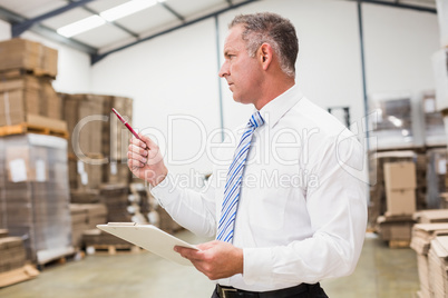 Warehouse boss checking his inventor