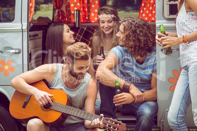 Hipster friends in camper van at festival