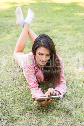 Woman using tablet in park