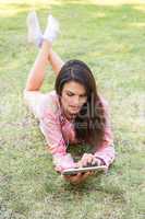 Woman using tablet in park