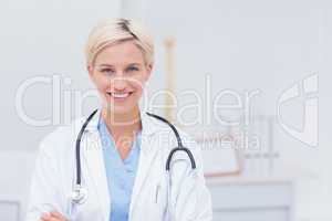 Confident female doctor smiling in clinic