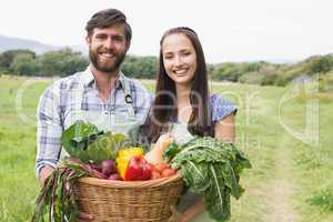 Happy couple with box of veg