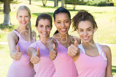 Smiling women in pink for breast cancer awareness