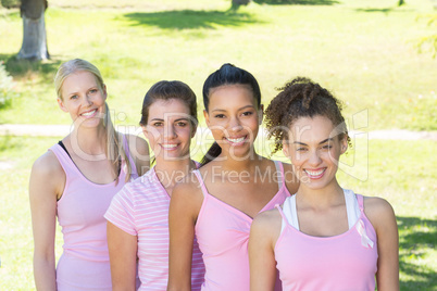 Smiling women in pink for breast cancer awareness