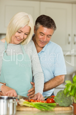 Happy mature couple making dinner together