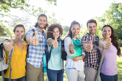 Smiling students showing thumbs up