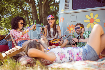 Happy hipsters relaxing on the campsite