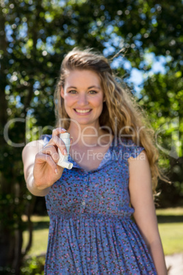 Pretty blonde showing her inhaler