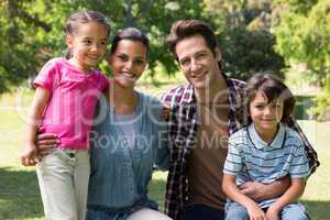 Happy family smiling at camera