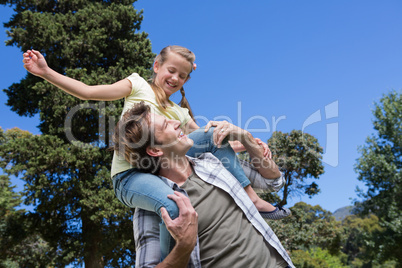 Father and daughter having fun in the park