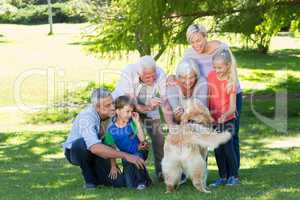 Happy family playing with their dog