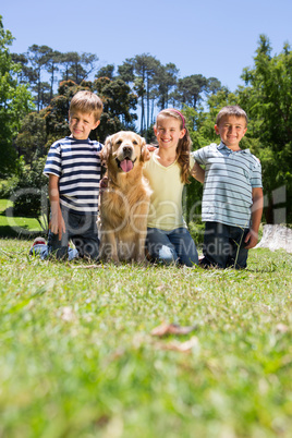 Happy siblings with their dog