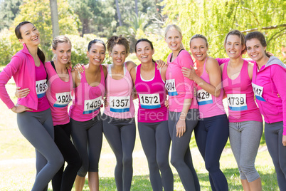 Smiling women running for breast cancer awareness