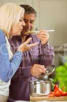 Mature couple preparing meal together