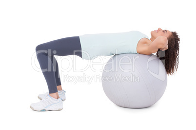 Fit woman doing sit ups on exercise ball