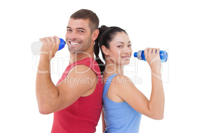 Fit man and woman smiling at camera together