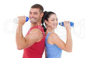 Fit man and woman smiling at camera together