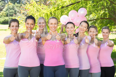 Smiling women in pink for breast cancer awareness