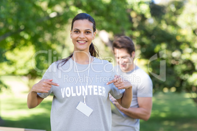 Happy volunteer brunette smiling at the camera Happy volunteer brunette smiling at the camera