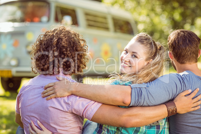 Hipster smiling at camera with friends